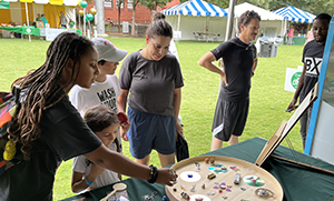 UNC-Greensboros Dr Meredith Powers leads an ongoing community-engaged environmentally oriented research project called All That We Share which celebrates North Carolinas refugee and other diverse communities through workshops and creating eco-art such as mosaics